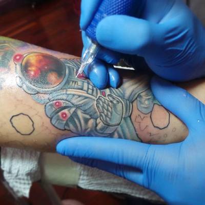 Astronaut tattoo work is progress at Ettore Bechis Tattoo Studio in Miami Beach